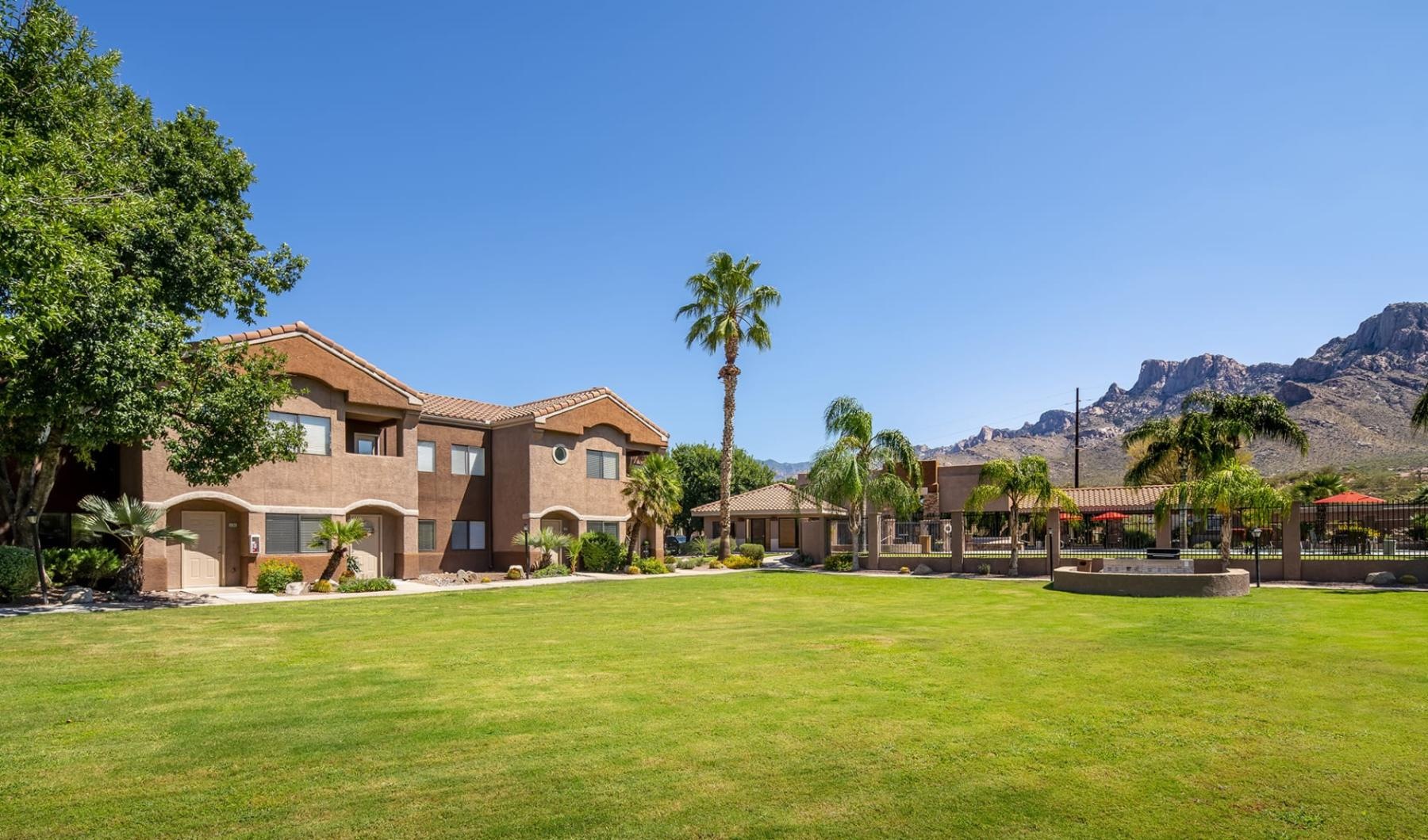 Find your perfect fit at Rock Ridge Apartments a large green field with trees and buildings in the background