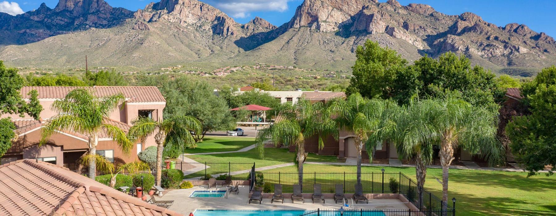 a pool in a backyard with mountains in the background