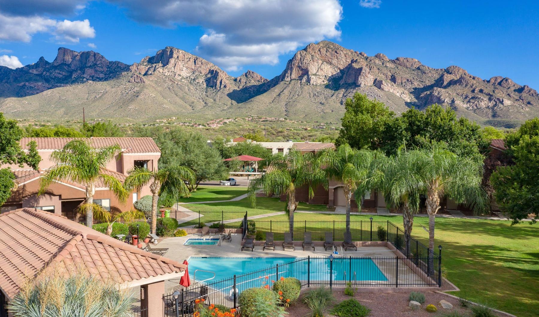 Find your perfect fit at Rock Ridge Apartments a pool in a backyard with mountains in the background